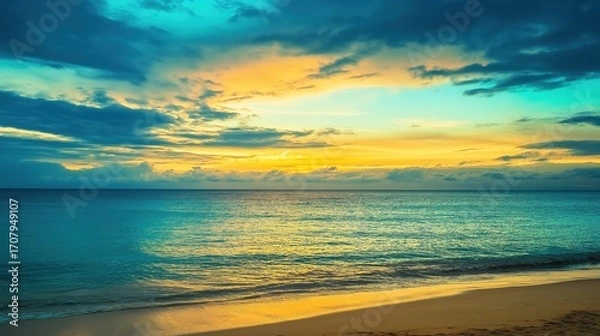 Fototapeta sand. A breathtaking tropical beach sunset with vibrant clouds and golden reflections on the wet sand. inspiring travel planning, travel magazines, designed for outdoor magazines and nature guides.