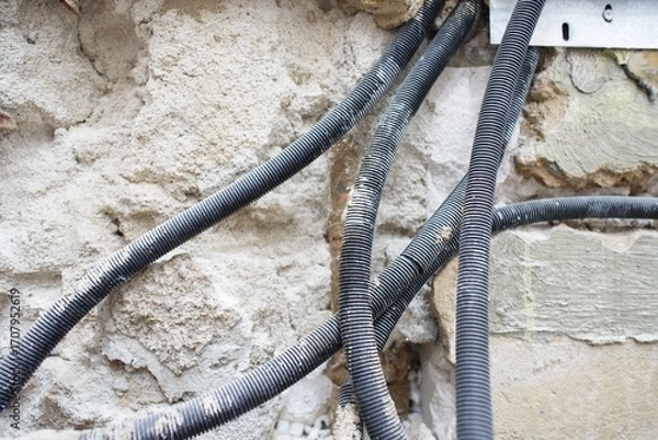 Fototapeta The plumbing work is currently in progress, showcasing exposed pipes and a bare floor in a bathroom renovation project