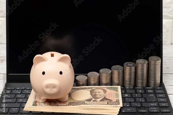 Obraz ノートパソコンと豚の貯金箱と一万円札