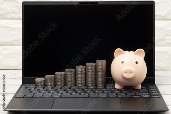 Obraz パソコンとブタの貯金箱とお金