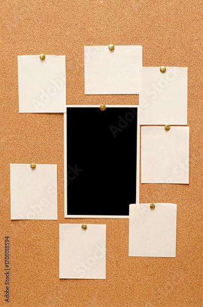 Fototapeta Blank paper notes and an empty photo are pinned to a cork board. The concept of detective investigation or a webinar.