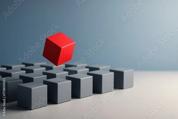 Fototapeta Red cube floating above uniform gray cubes on neutral background symbolizing leadership individuality innovation and standing out concepts