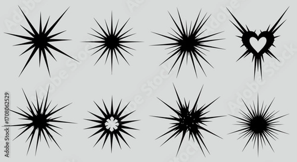 Fototapeta Set of Black Starburst Shapes on a Light Background