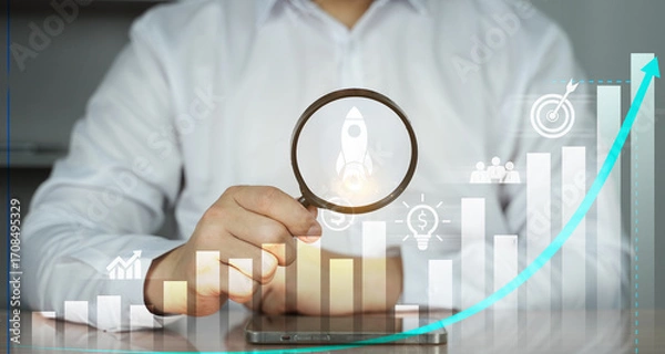 Fototapeta Businessman analyzing growth chart with magnifying glass, data analytics, financial investment, and business success concept.