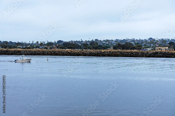 Fototapeta Mission Bay Entrance Channel with slowly moving motorboat near navigational buoy in a direction of the exit to Pacific ocean, San Diego, California