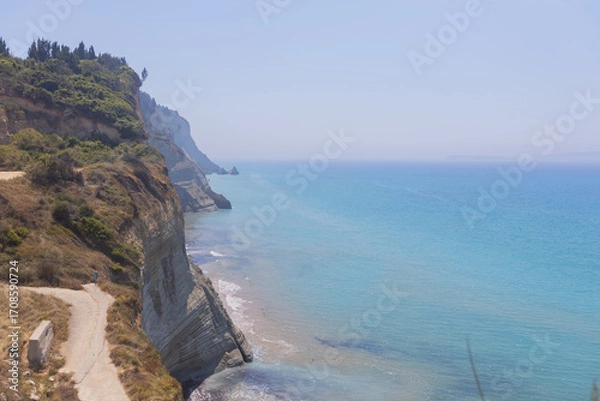 Fototapeta Breathtaking view of turquoise waters meeting rugged cliffs from a scenic terrace, ideal for travel, lifestyle, and nature-inspired branding.