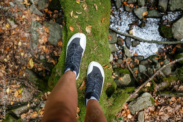 Fototapeta Woman legs with barefoot hiking shoes in the  mountain