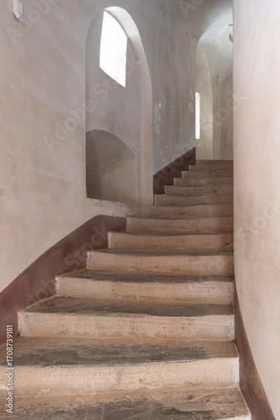 Fototapeta Interior detail of staircase leading up between whitewashed walls