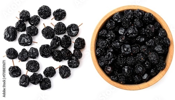 Obraz Dried Black Plums in Wooden Bowl, Top View, Isolated on White Background