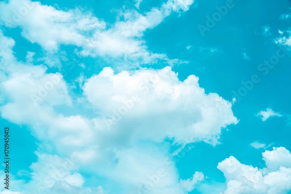 Fototapeta Bright blue sky filled with fluffy white clouds on a sunny day capturing the beauty of nature and the atmosphere