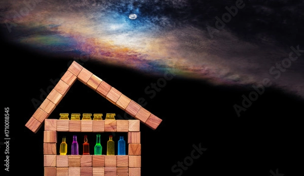 Fototapeta Wooden cubes arranged to form a simplistic house with various miniature bottles of alcohol without labels and gold bars in the attic against black bacground