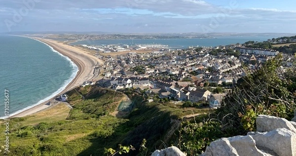 Fototapeta Chesil Beach on the left and Portand harbour on the right in Dorset UK