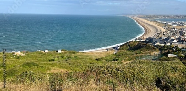 Fototapeta Chesil beach stretching around Lyme Bay in Dorset with Portland harbour on the left hand side