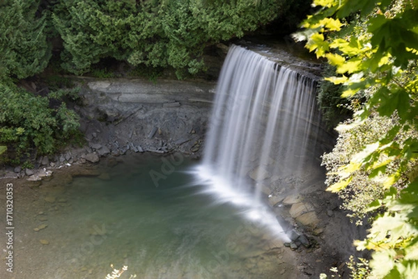 Obraz Bridal Veil Falls on Manitoulin Island offers a serene and picturesque glimpse into Ontario's natural beauty with its cascading waters and lush surroundings.