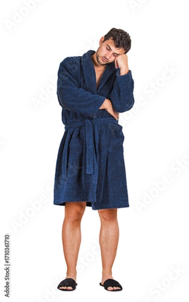 Fototapeta Full length portrait of sleepy young man wearing bathrobe, falls asleep while standing and waiting, leaning on his hand with eyes closed, feels tired isolated on transparent background