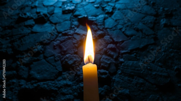 Obraz burning candle on black background