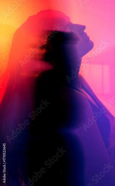 Obraz moody experimental portrait of a brunette woman with orange-pink-red glow in cyberpank style