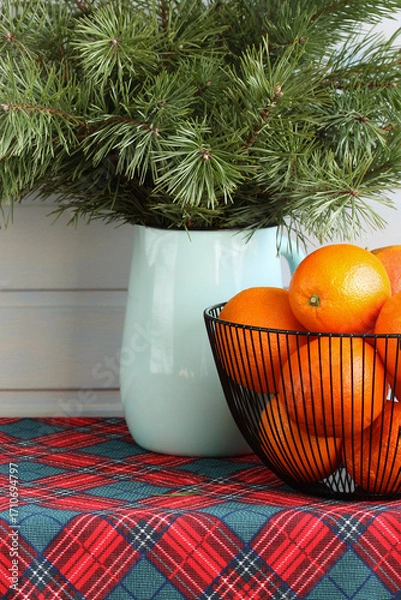 Fototapeta Christmas oranges and pine branches creating festive atmosphere