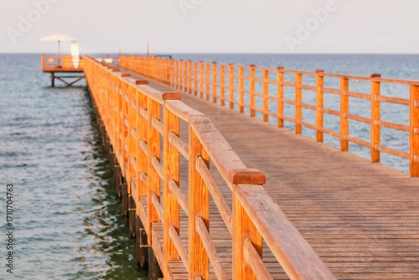 Fototapeta Wooden pier for swimming in the Red Sea is made to avoid damaging the corals. Selective focus