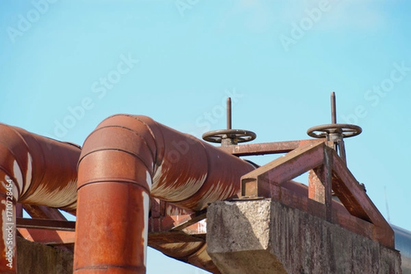 Fototapeta rusty pipeline against blue sky