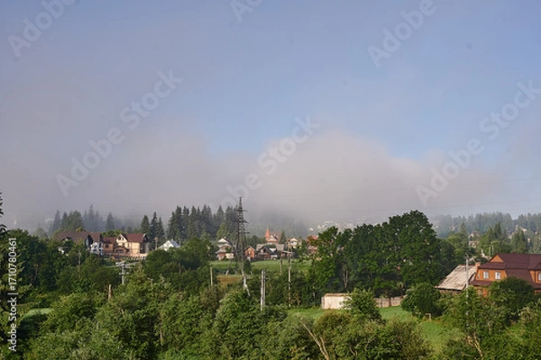 Obraz fog in the mountains houses at altitude green forest summer