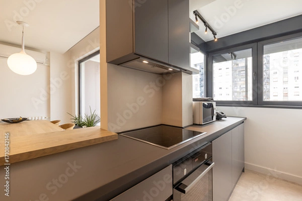 Obraz Modern kitchen with built-in appliances and large windows