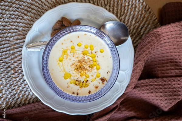 Obraz Homemade recipe for white vegetable cream soup with almonds