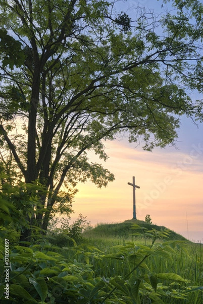 Obraz Cross on a hill during sunset.