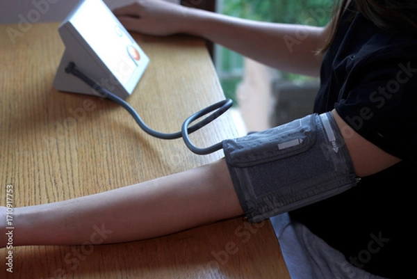 Obraz Blood Pressure Monitor Cuff on Left Arm Measuring Hypertension.