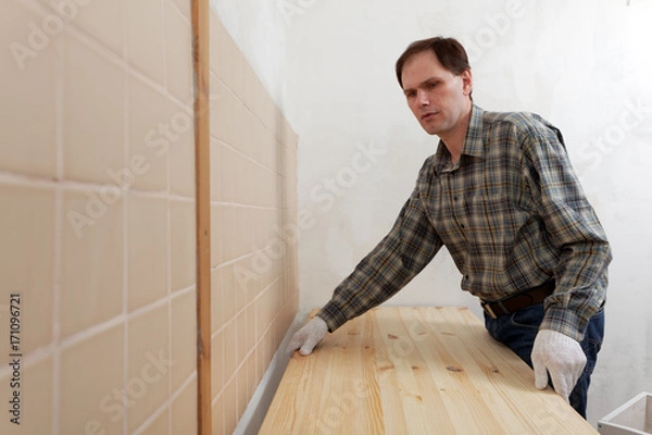 Fototapeta Worker installing a countertop