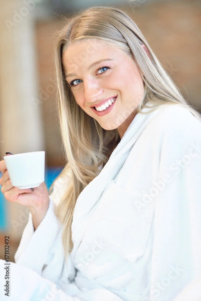 Fototapeta Horizontal view of woman drinking tea in spa