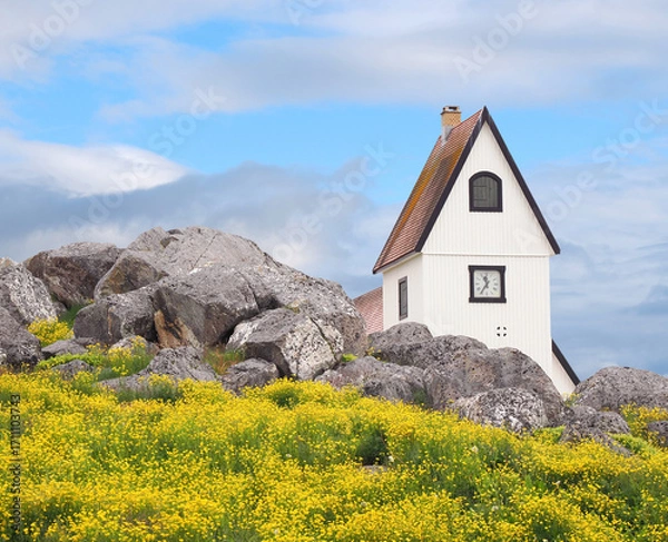 Fototapeta The Nanortalik, Greenland Church Hiding Behind the Iconic Boulders and Flowers of the Area
