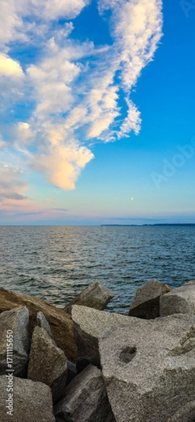 Fototapeta Baltic Sea Rocky Shoreline with Cloudy Sky and moon sunset