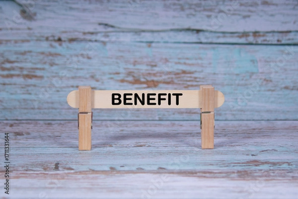 Fototapeta Benefit symbol. Single Wooden stick squeezed by Clothespins, Grungy blue Wooden Texture Background. Business and Benefit concept with copy space