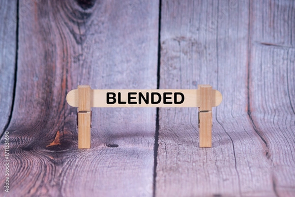 Fototapeta Blended symbol. Single Wooden stick supported by Clothespins, beautiful Light Orange tone highlight Wooden Texture Background. Business and Blended concept with copy space