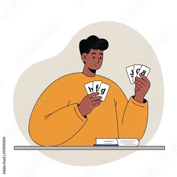 Fototapeta Dark-haired man in orange sweater smiles while holding lettered cards near books