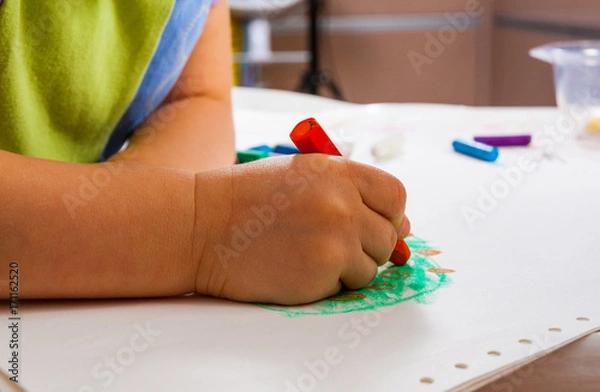 Fototapeta the baby's hands are painted with colored crayons
