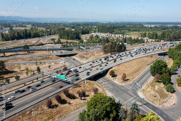 Fototapeta Aerial drone picture of Interstate 5 freeway traffic near Portland, Oregon, with northbound vehicles traveling toward Vancouver, Washington, near I-5 bridge, showing congestion and transport flow