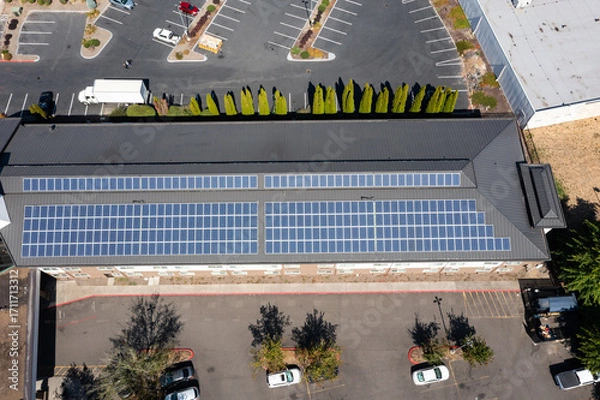 Fototapeta Modern hotel building in Portland, Oregon with rooftop solar panels captured in 4K aerial drone footage, highlighting renewable energy, green technology, clean power, sustainable architecture design