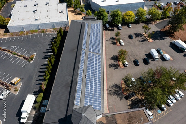 Fototapeta Modern hotel building in Portland, Oregon with rooftop solar panels captured in 4K aerial drone footage, highlighting renewable energy, green technology, clean power, sustainable architecture design