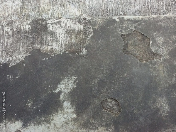 Fototapeta Aged and peeling paint on a textured concrete surface