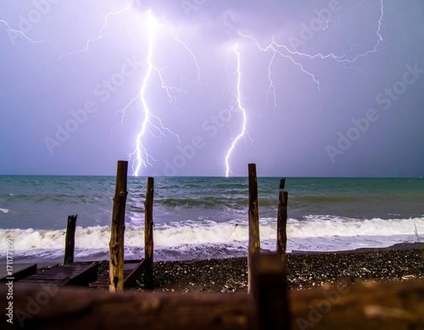 Obraz Dramatic lightning storm over a beach