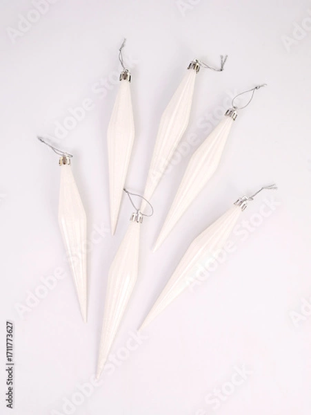 Obraz White icicles toys on the Christmas tree on a white background, Christmas and New Year concept