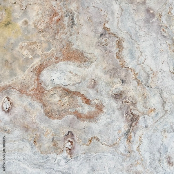 Fototapeta Natural stone texture with earthy tones of gray and rusty orange, showcasing rough surface patterns and organic details, ideal for backgrounds or design