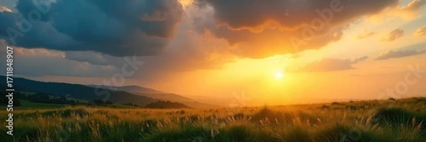Fototapeta Warm sunlight streams through gaps in clouds, illuminating a landscape bathed in golden light  Perfect for nature, weather, energy, and environmental themes ,  sunlit,  golden rays,  natural light