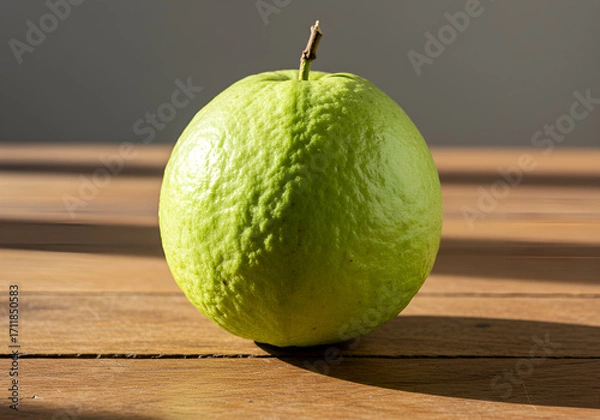 Fototapeta Fresh whole guava fruit on wooden table with natural sunlight and raw texture