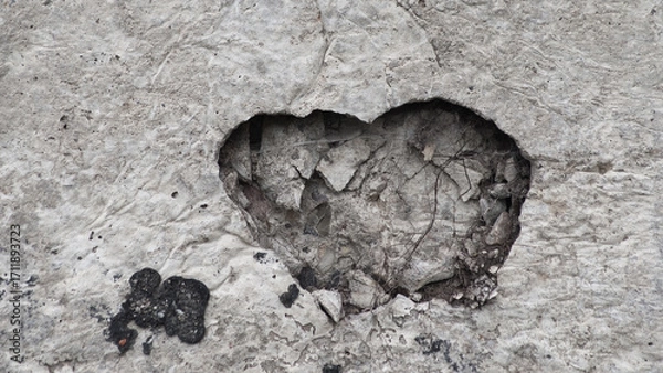 Fototapeta gray background, in the photo a concrete wall and a recess in the shape of a heart