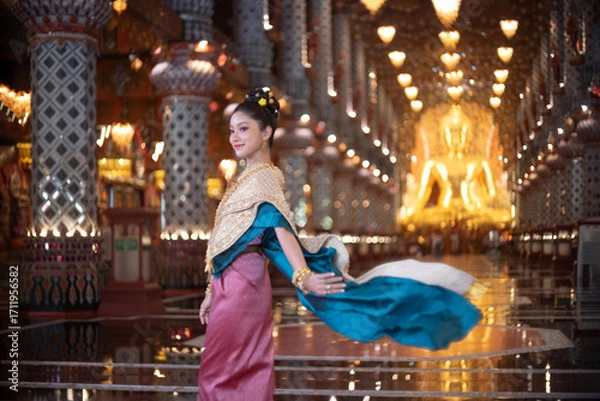 Fototapeta Beautiful young Asian woman in traditional Myanmar dress in an old temple in Chiang Mai, Thailand. 