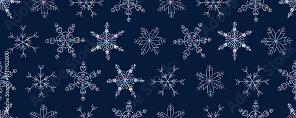 Fototapeta Vector seamless pattern of decorative snowflakes with pastel gradient lines on a dark blue background. Winter festive design for packaging, textiles, wallpaper, cards and holiday decor