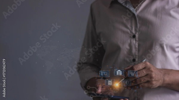 Fototapeta Young man with smartphone mobile hand holding a pen touching to visualize money growth The phone screen displays graphs and charts showing increasing investment and savings trends, increased